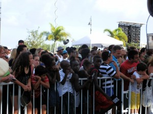 footbll players line the barricades near the stage to get the closest view of the action